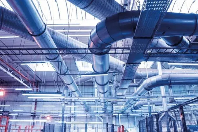 HVAC estimating services: overhead ductwork and cable tray in a commercial building